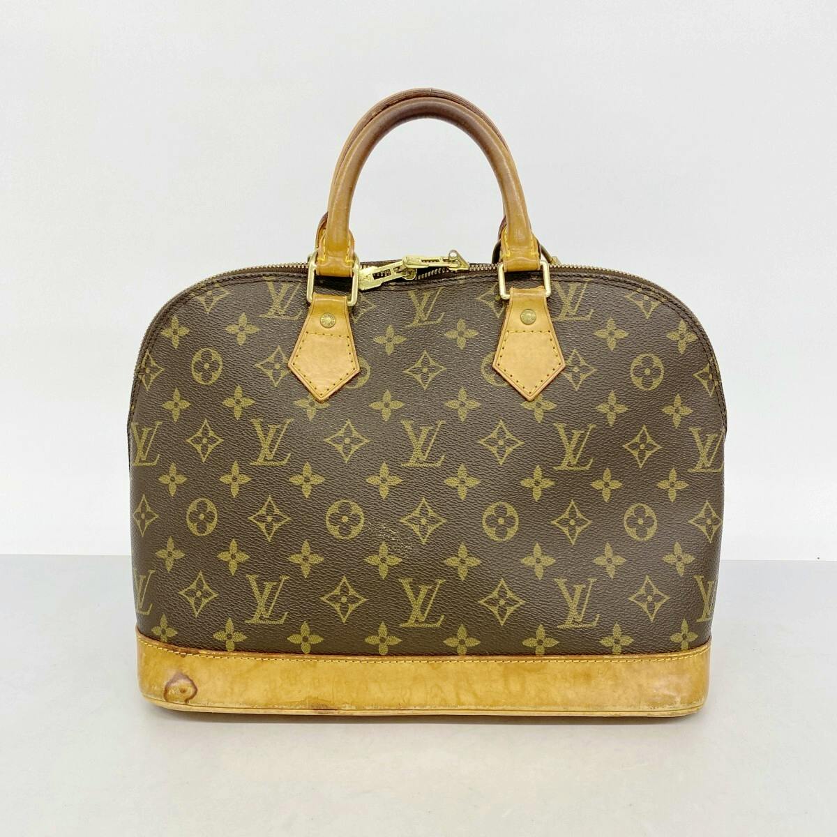 Front view of a Louis Vuitton Monogram Alma handbag (M51130) in brown with leather handles and monogram canvas.