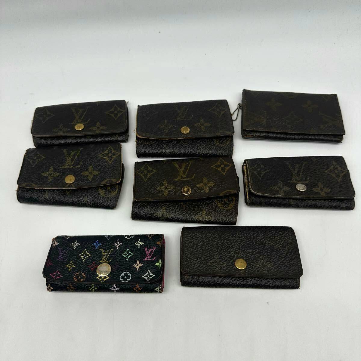 Eight Louis Vuitton key cases and pass cases in monogram and multicolor canvas arranged on a white background.