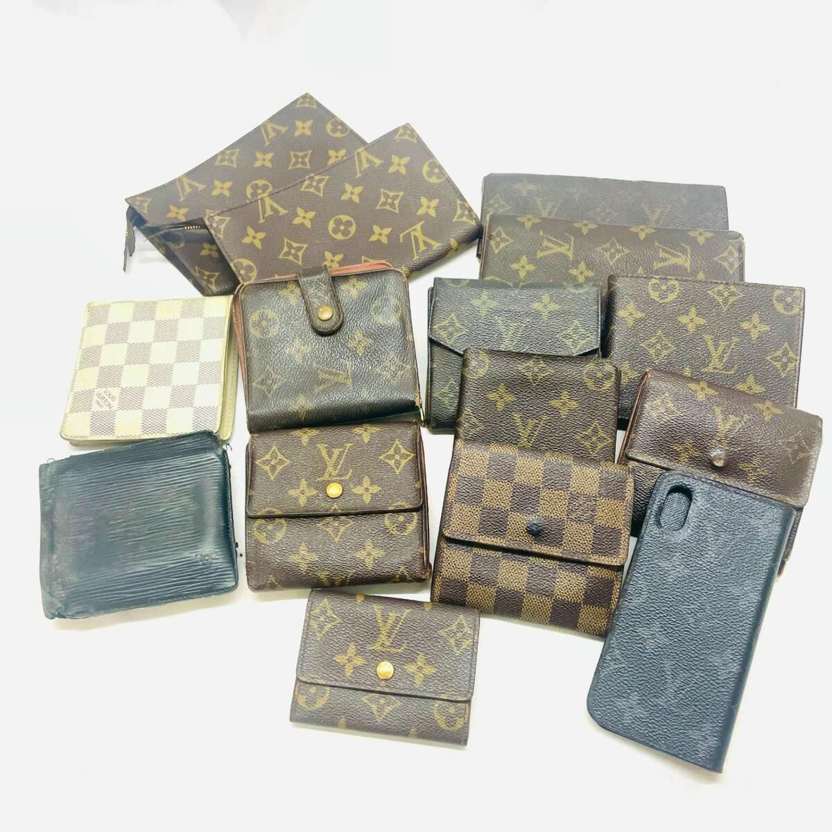 Multiple Louis Vuitton monogram and Damier canvas wallets and small pouches arranged on a white background.