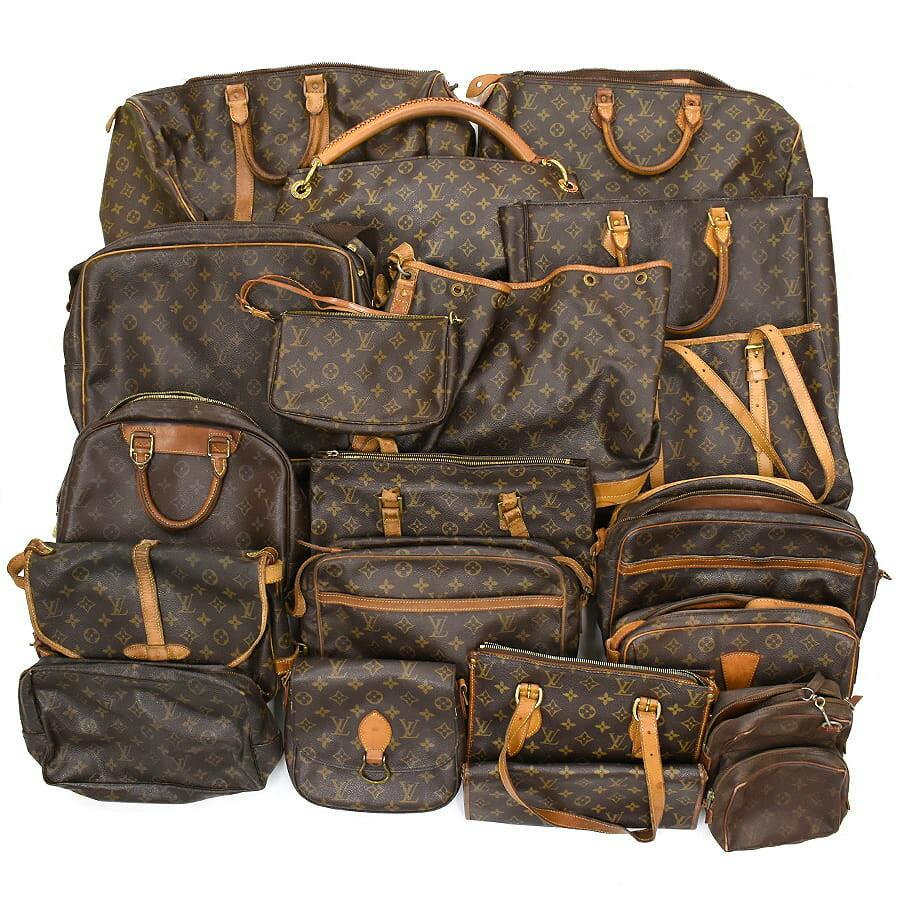 A grouped set of multiple Louis Vuitton monogram canvas bags, pouches, and clutches displayed together.