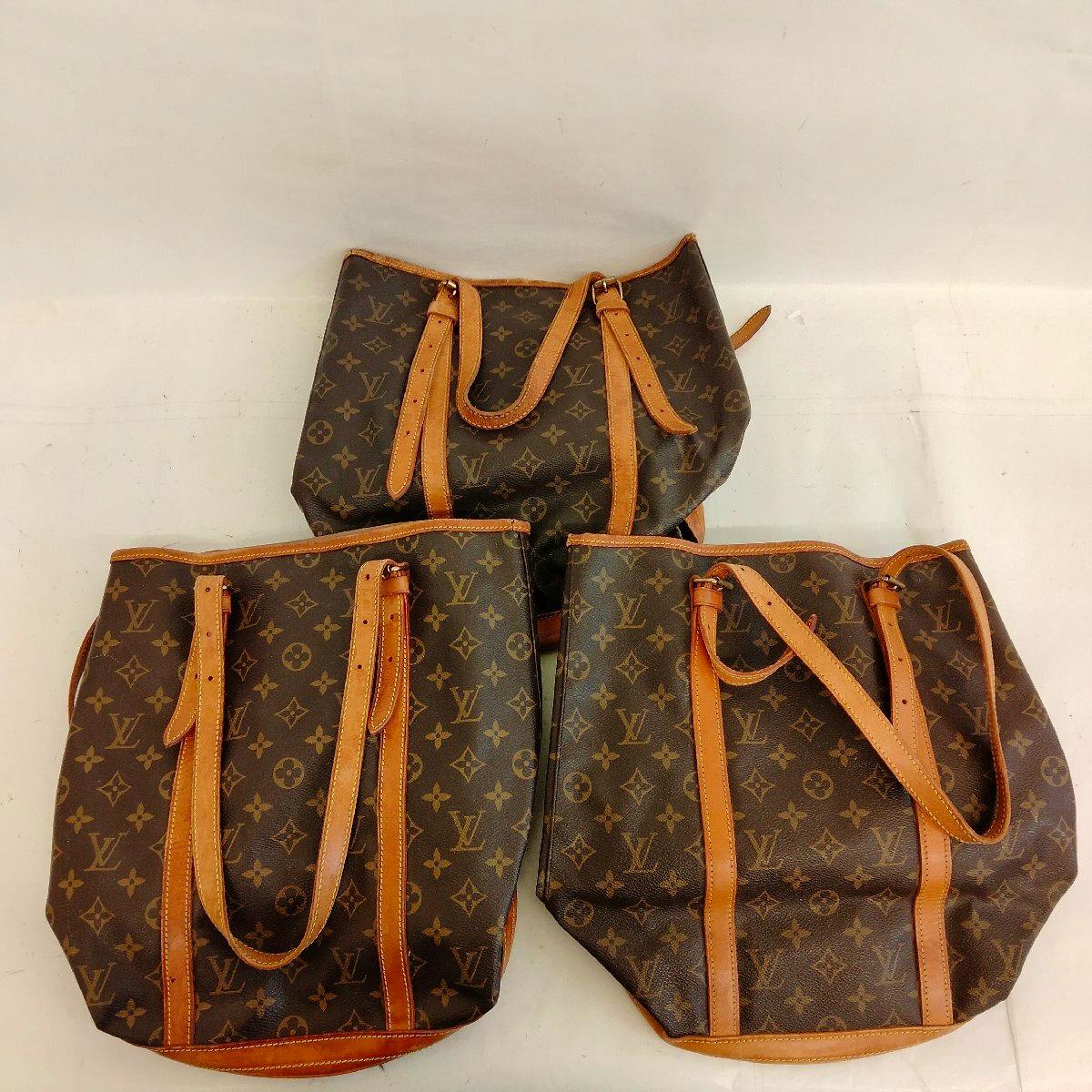 Three Louis Vuitton monogram bags with leather straps arranged on a white background.
