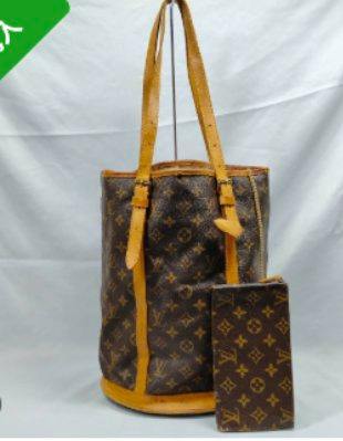 Front view of the Louis Vuitton Monogram Bucket GM bag with a matching monogram pouch against a white background.