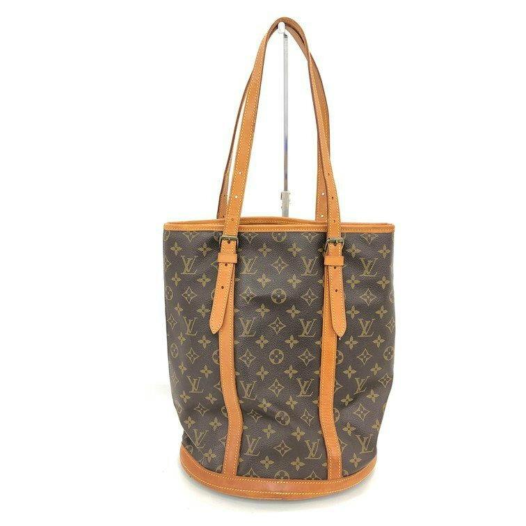 Front view of a Louis Vuitton Monogram Bucket GM shoulder bag showing monogram canvas with vachetta leather trim and shoulder straps.