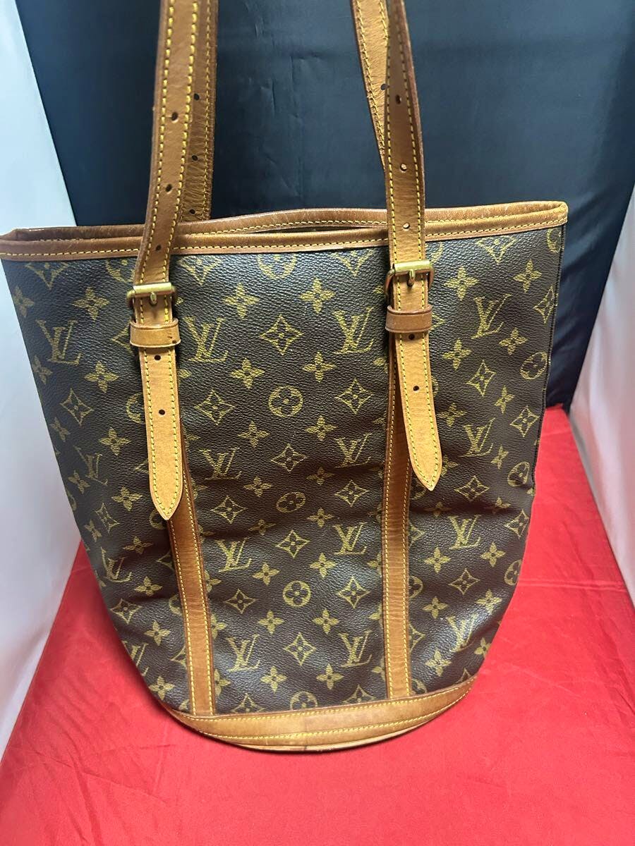 Front view of the Louis Vuitton Monogram Bucket GM tote bag showing monogram canvas with leather trim and shoulder straps.
