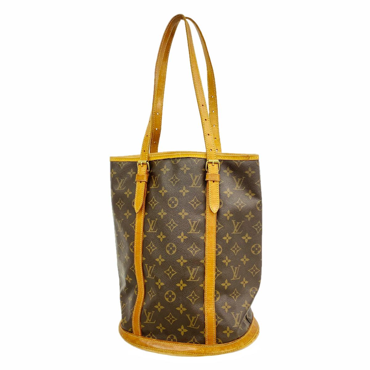 Brown Louis Vuitton Monogram Bucket GM tote bag with vachetta leather trim and long shoulder straps on a white background.