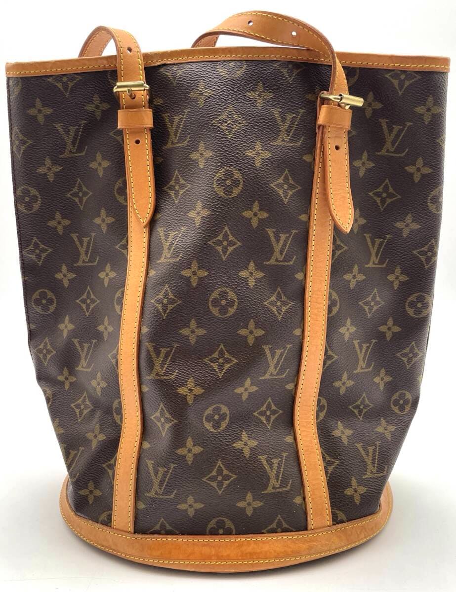 Front view of a Louis Vuitton Monogram Bucket GM canvas tote with vachetta leather trim and shoulder straps.