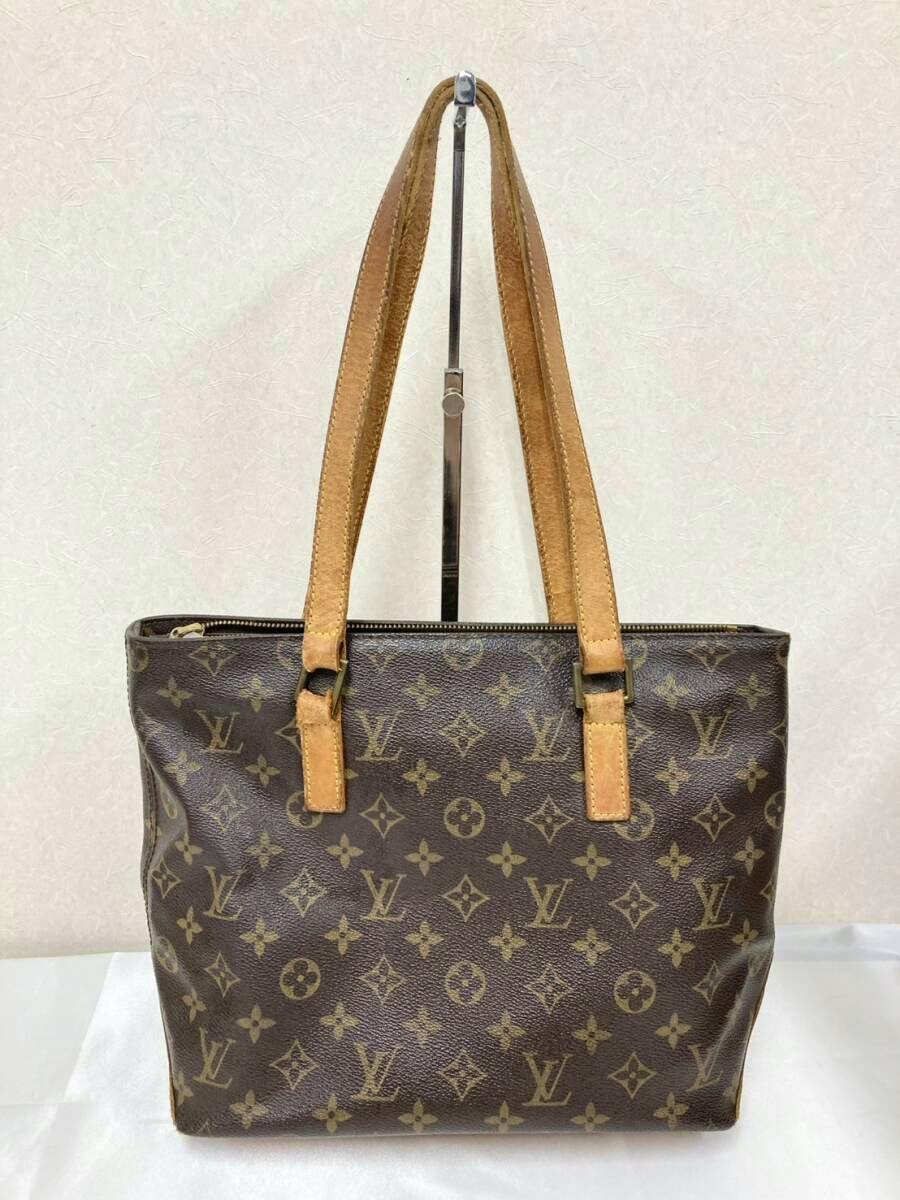 Front view of a Louis Vuitton monogram canvas bag with two shoulder straps.