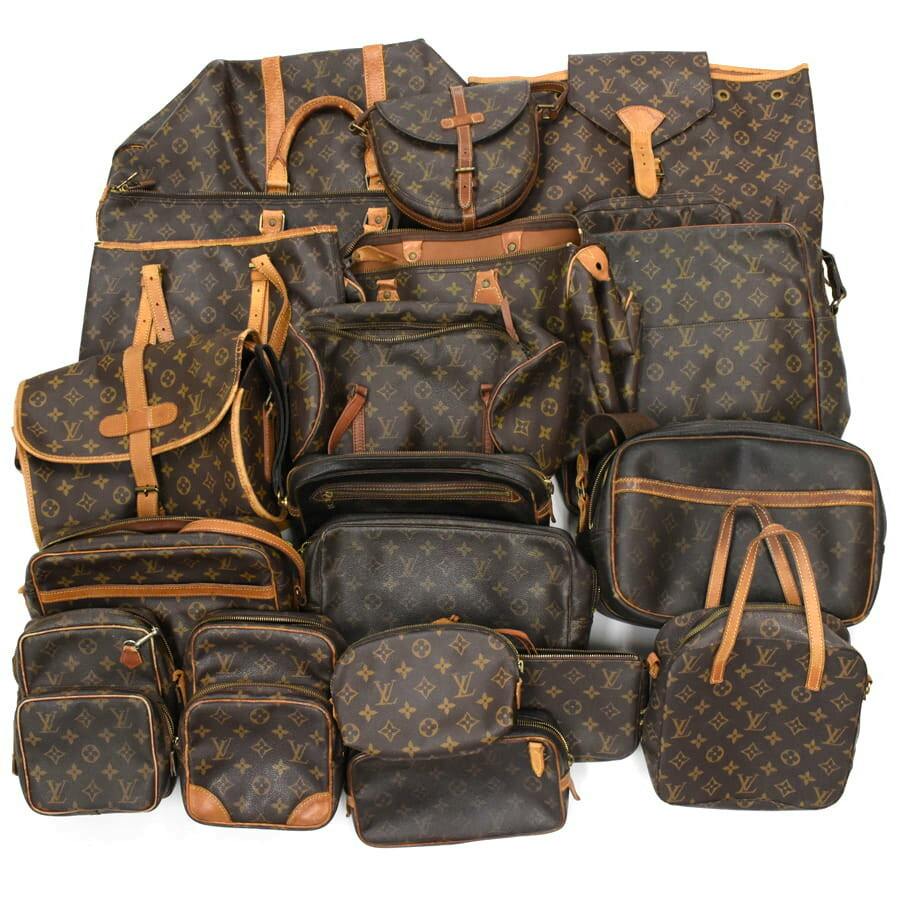 A group of Louis Vuitton monogram canvas bags, pouches, and clutches arranged together.