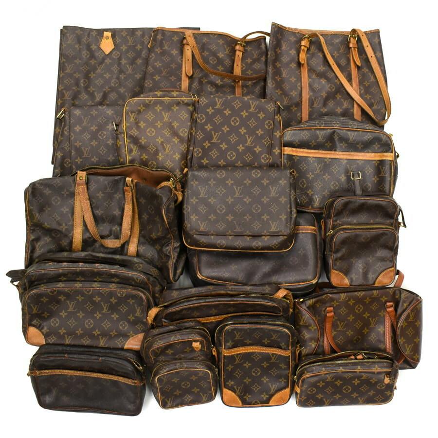Eighteen Louis Vuitton monogram canvas shoulder and hand bags arranged together in a grouped display for a bulk set.