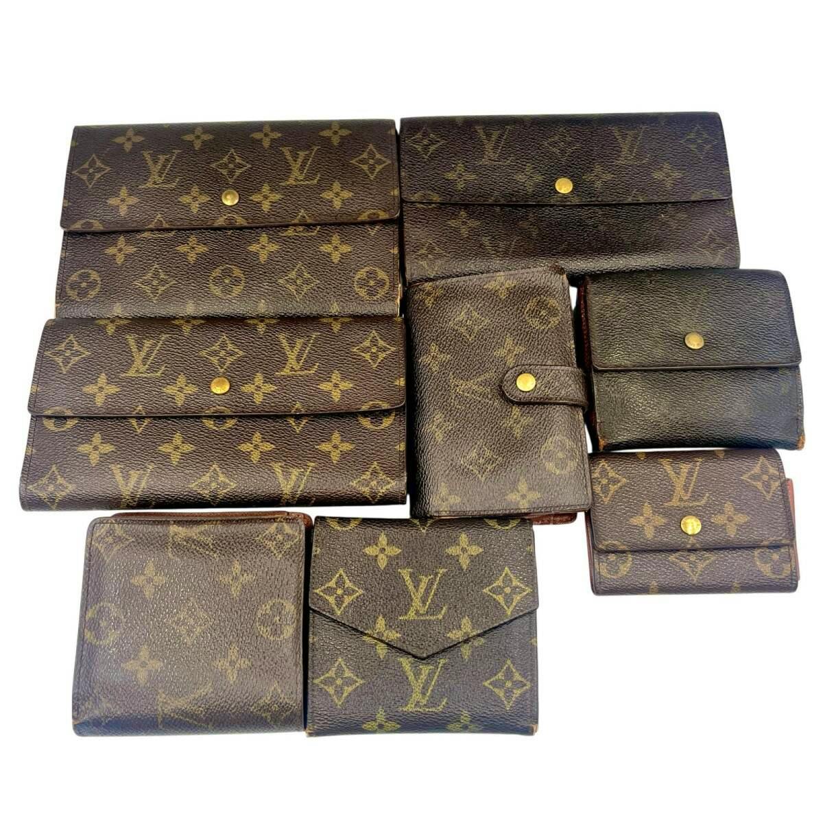 Eight Louis Vuitton monogram canvas wallets and small coin purses arranged on a white background.