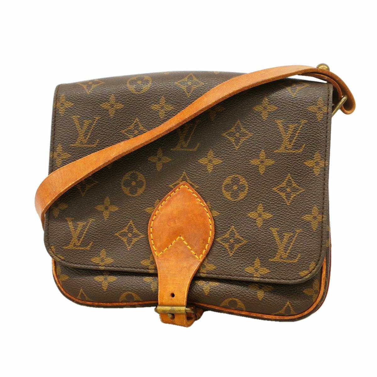 Front view of the Louis Vuitton Monogram Cartouchière MM brown shoulder bag showing monogram canvas, leather strap, and front buckle.