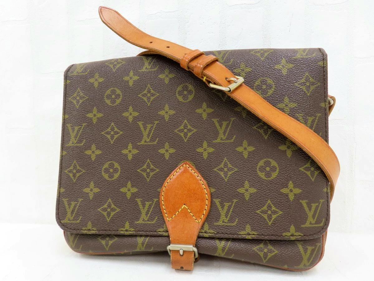 Front view of the Louis Vuitton monogram shoulder bag showing brown monogram canvas and a calf leather strap with buckle.