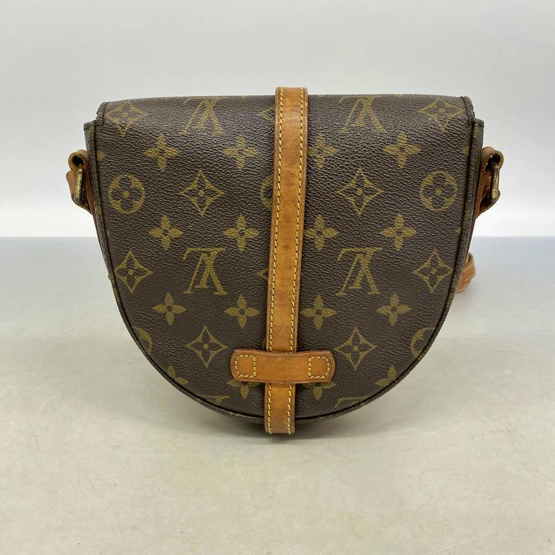 Front view of the brown monogram shoulder bag with a central leather strap and leather trim.