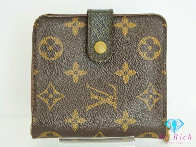 Front exterior of a Louis Vuitton monogram bi-fold wallet with a snap-button tab shown on a white background.