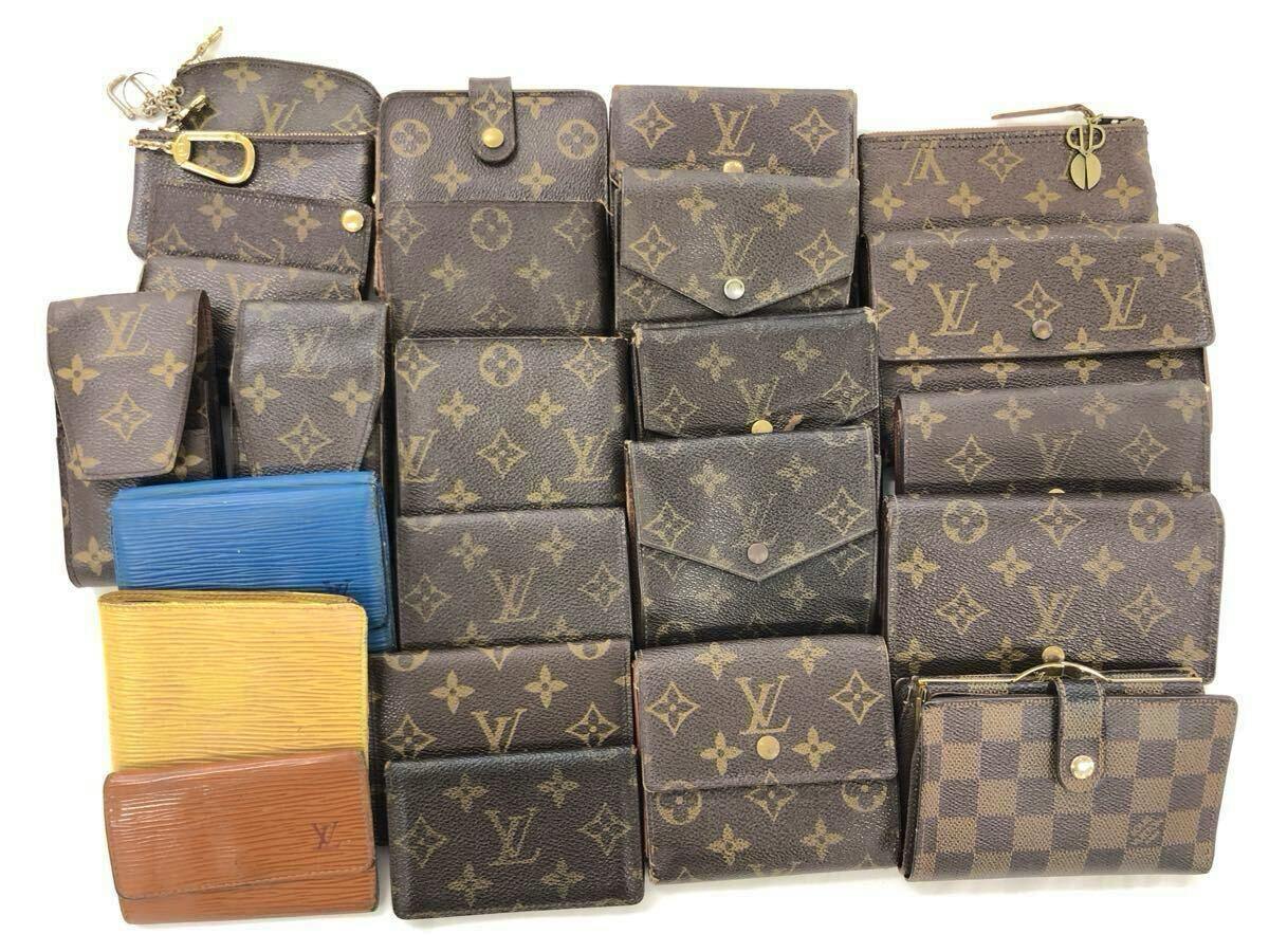 Multiple Louis Vuitton monogram and colored leather wallets arranged in rows on a white background.