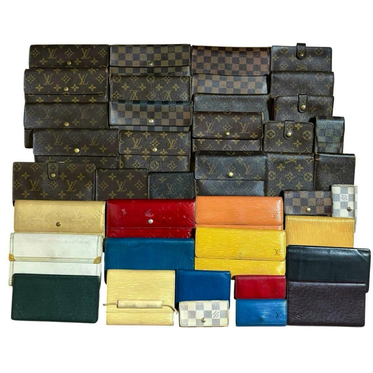 A large assortment of Louis Vuitton wallets and small leather goods in monogram, Damier, and Epi leathers arranged in rows on a white background.
