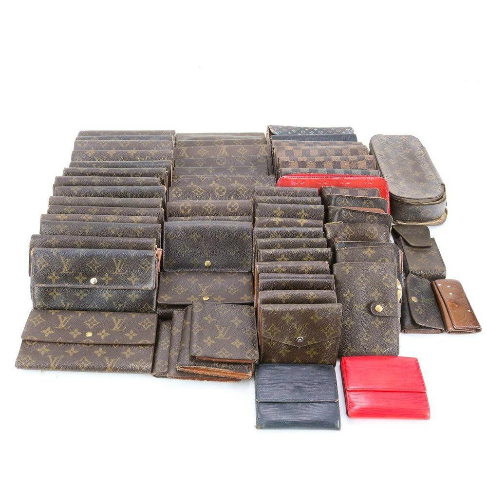 Multiple Louis Vuitton monogram and Damier wallets and small leather goods arranged on a white background.