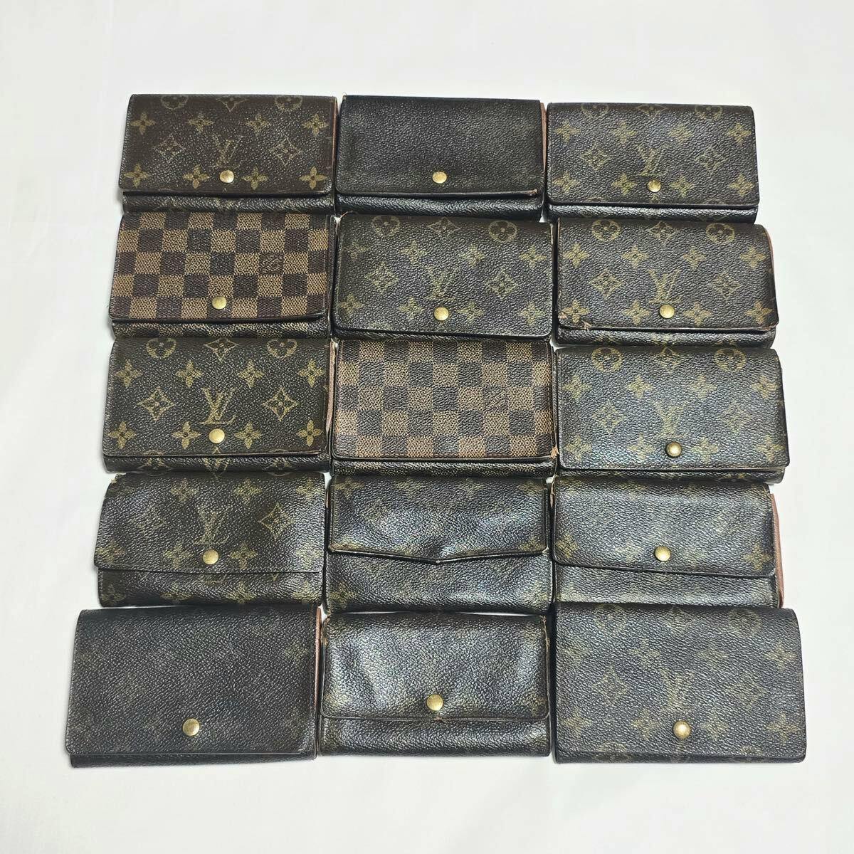 Fifteen Louis Vuitton wallets in monogram and Damier canvas arranged in rows on a white background.