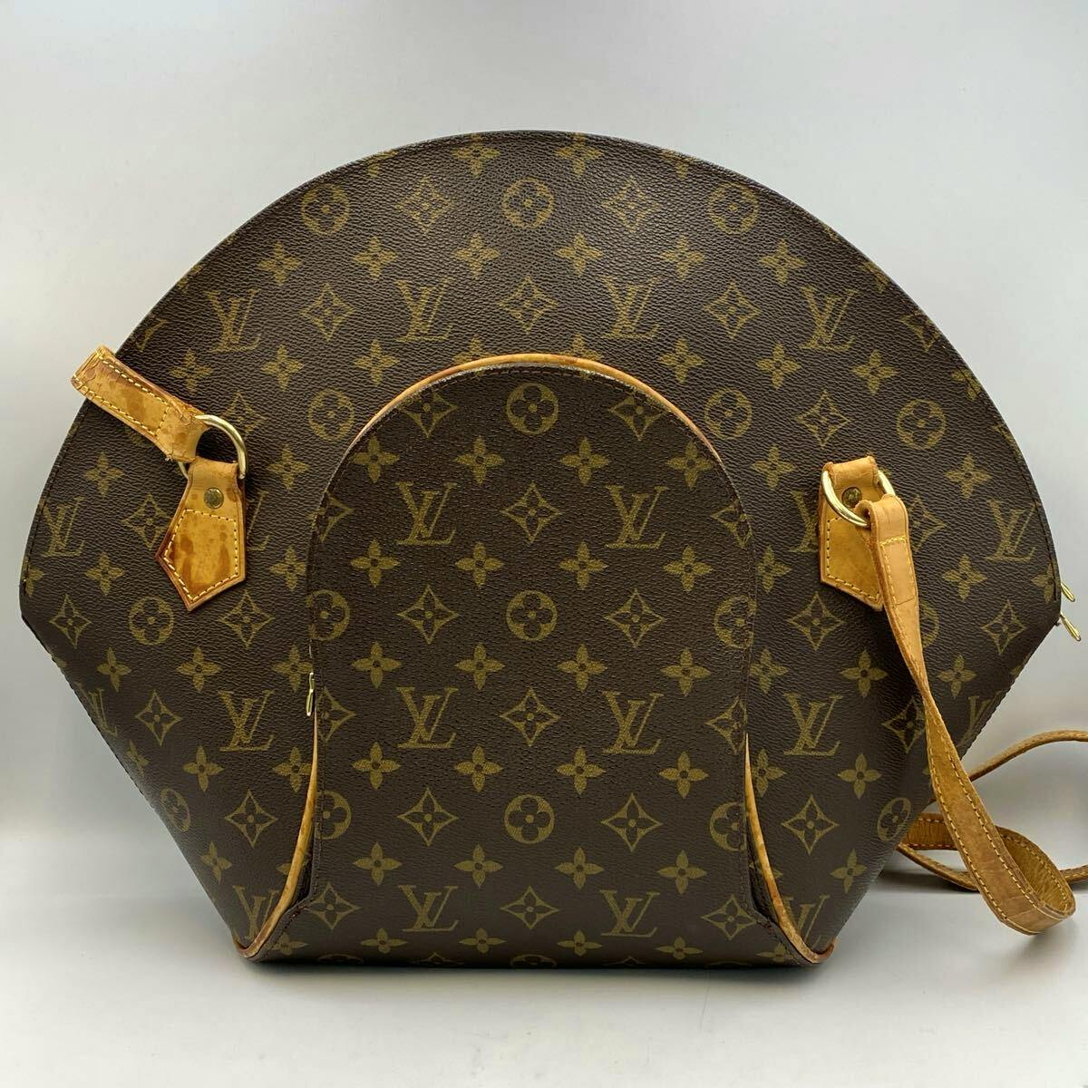 Front view of the Louis Vuitton monogram Ellipse shopping handbag showing monogram canvas and leather straps.