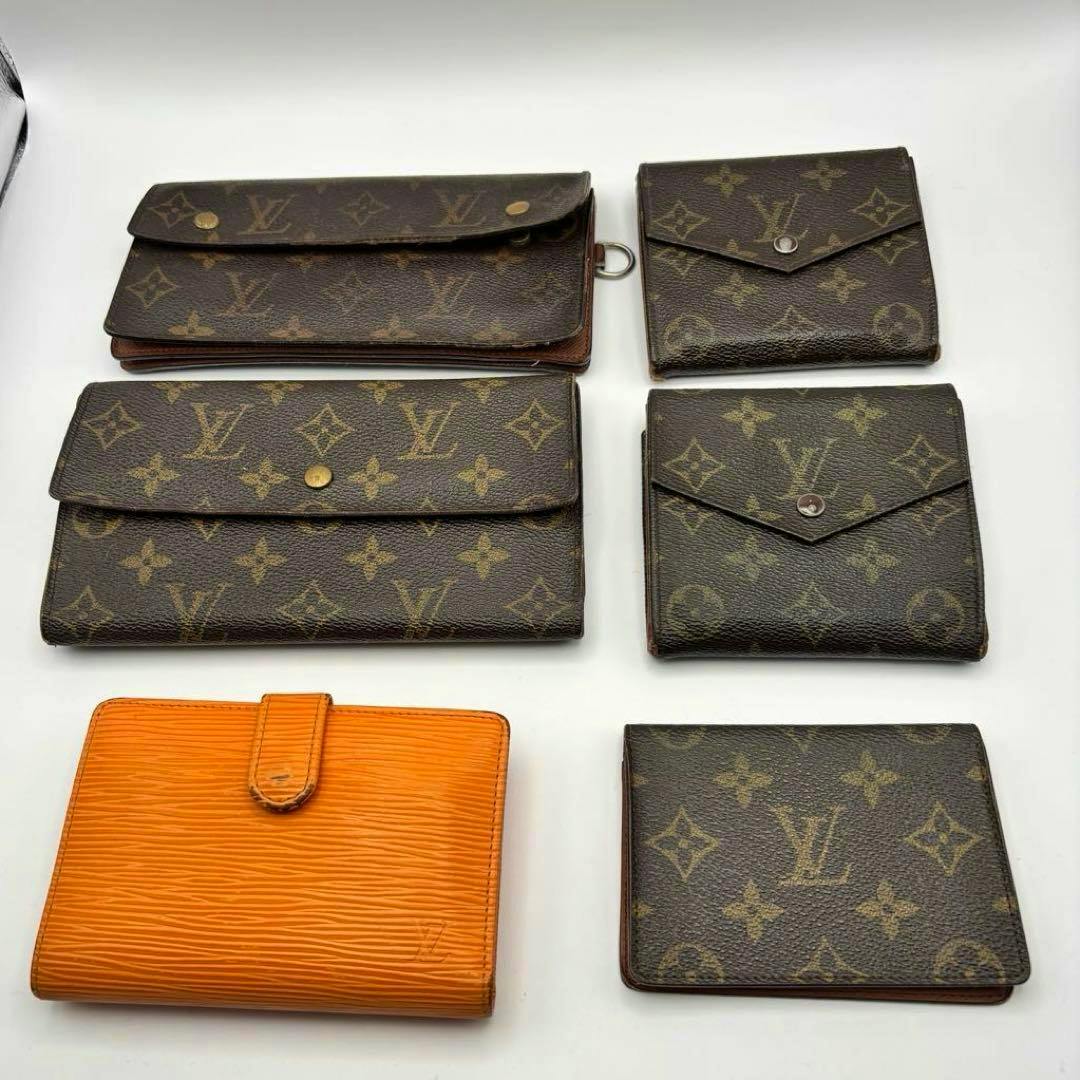 Six Louis Vuitton wallets and card cases (Monogram canvas and orange Epi leather) arranged on a white background.