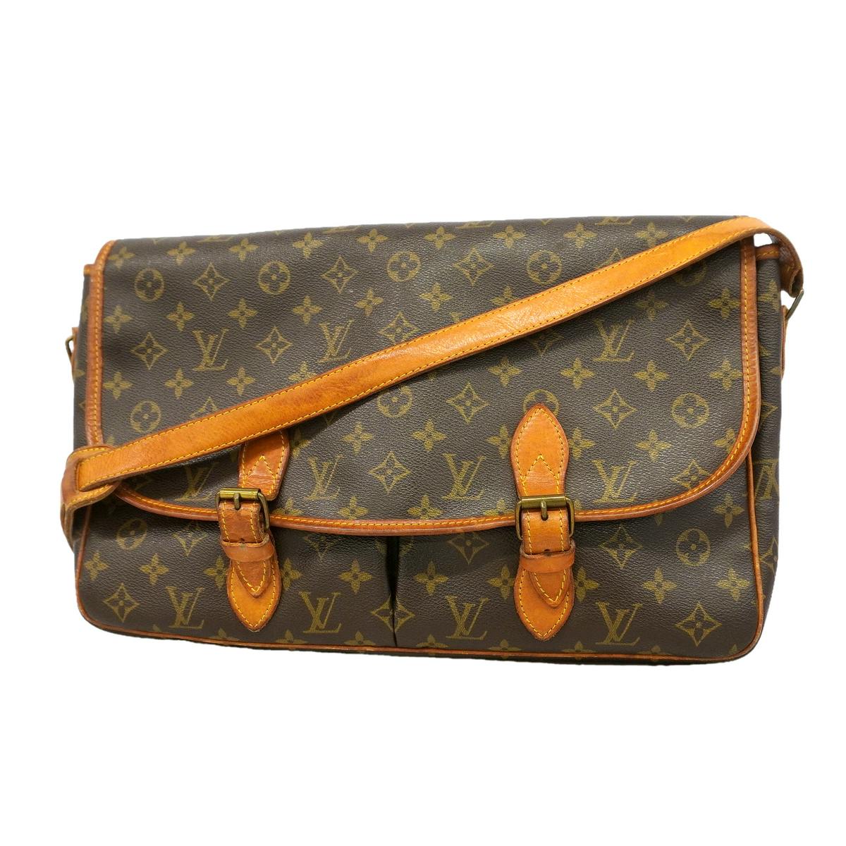Front view of the brown Louis Vuitton Monogram Gibeciere GM shoulder bag with tan leather trim and buckled straps.