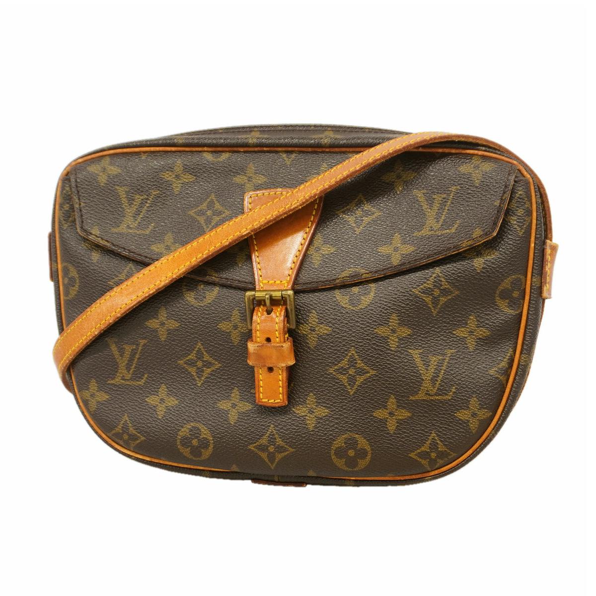 Front view of the brown Louis Vuitton monogram shoulder bag with a leather strap across the flap.
