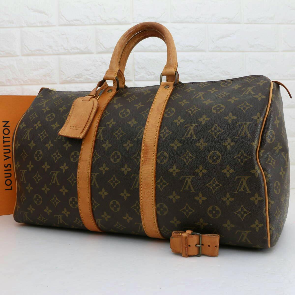Brown Louis Vuitton Monogram Keepall 45 travel duffel bag with leather handles and a luggage tag.
