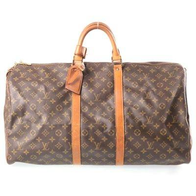 Front view of the LOUIS VUITTON Monogram Keepall 55 duffel bag in brown monogram PVC canvas with leather handles and straps on a white background.