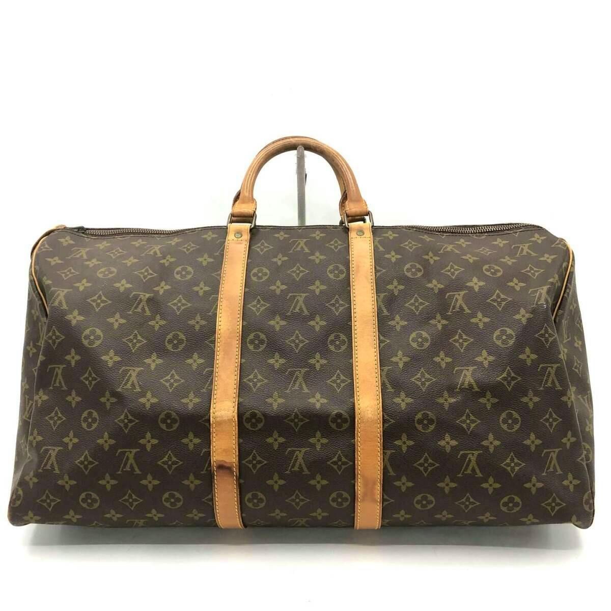 Front view of a Louis Vuitton Monogram Keepall 55 (M41424) canvas duffel bag with leather handles and straps on a white background.