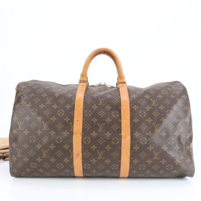 Brown Louis Vuitton Monogram Keepall 55 duffel bag with leather handles and straps shown from the front.