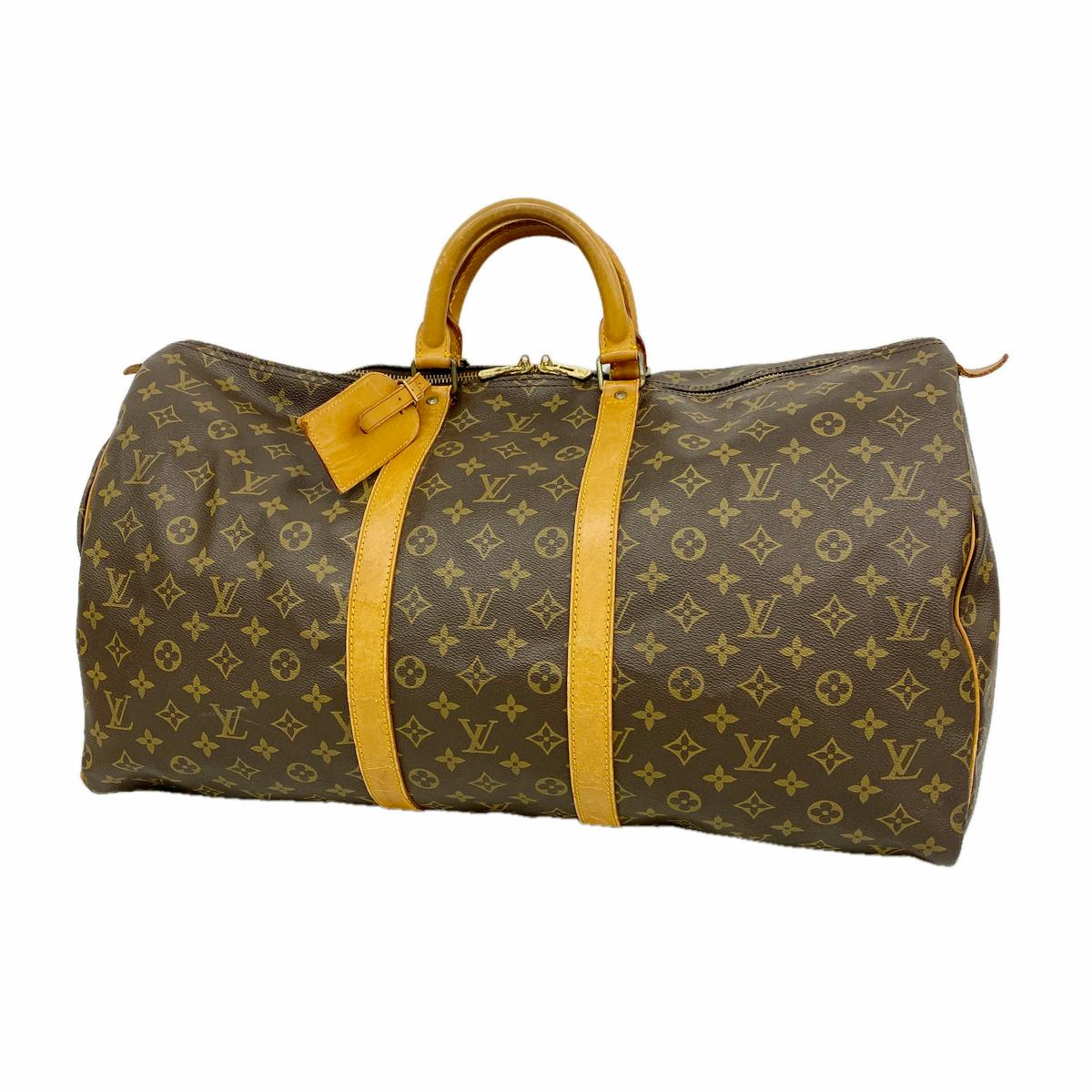 Louis Vuitton Monogram Keepall 55 duffle bag with brown monogram canvas and tan leather handles and straps on a white background.