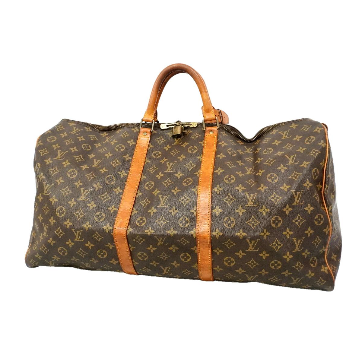 Brown Louis Vuitton Monogram Keepall 60 duffel bag with tan leather handles and straps on a white background.
