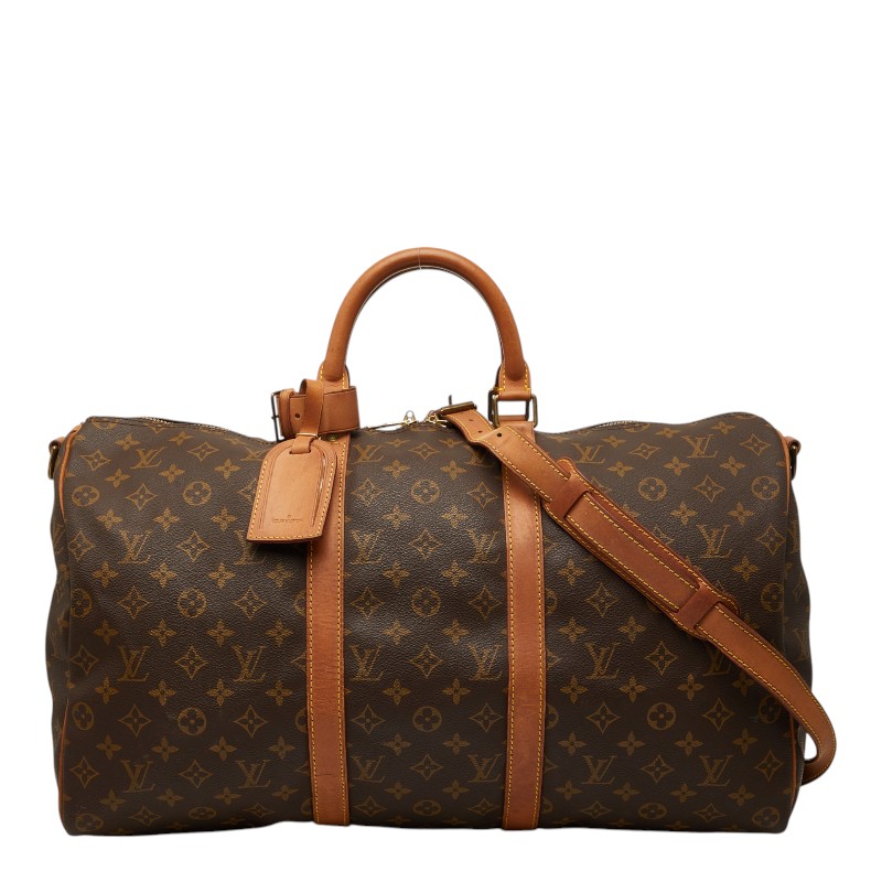 Front view of a brown Louis Vuitton Monogram Keypol/Bandouliere 50 duffel bag with leather handles and an adjustable shoulder strap.