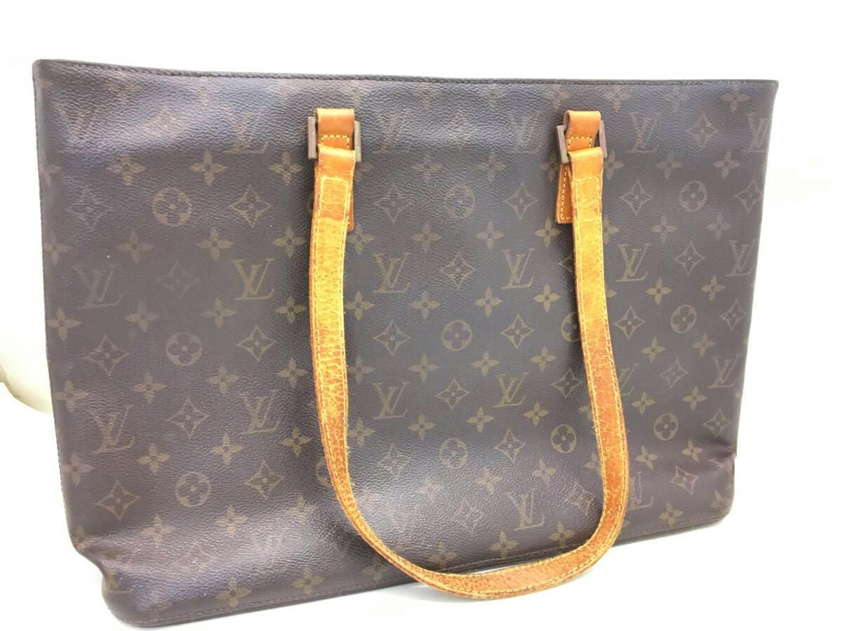 Front view of the Louis Vuitton monogram canvas tote bag with leather shoulder straps.