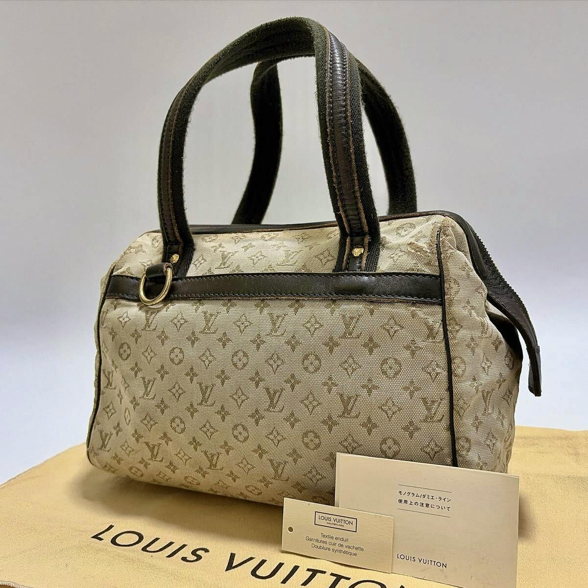 Khaki Louis Vuitton Monogram Mini Josephine PM canvas and leather handbag shown on a Louis Vuitton dust bag with accompanying booklets.