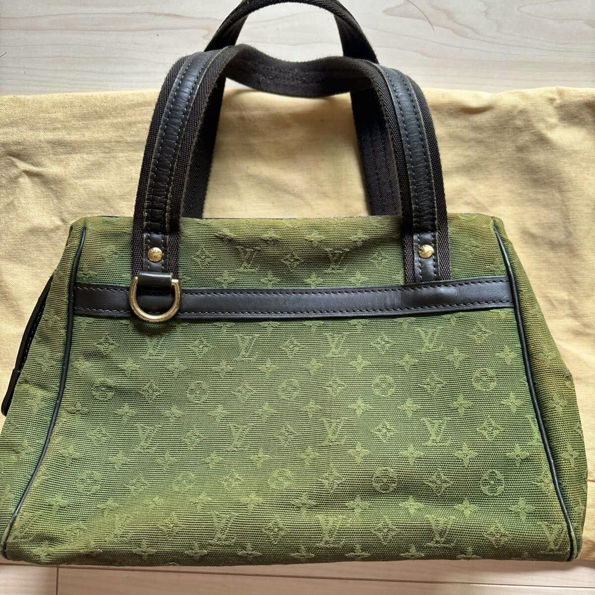 Front view of the khaki Louis Vuitton Monogram Mini Josephine PM canvas handbag with dark handles and visible embossed monogram pattern.