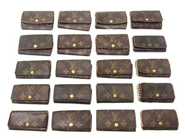 Twenty Louis Vuitton monogram key cases arranged in a grid on a white background.