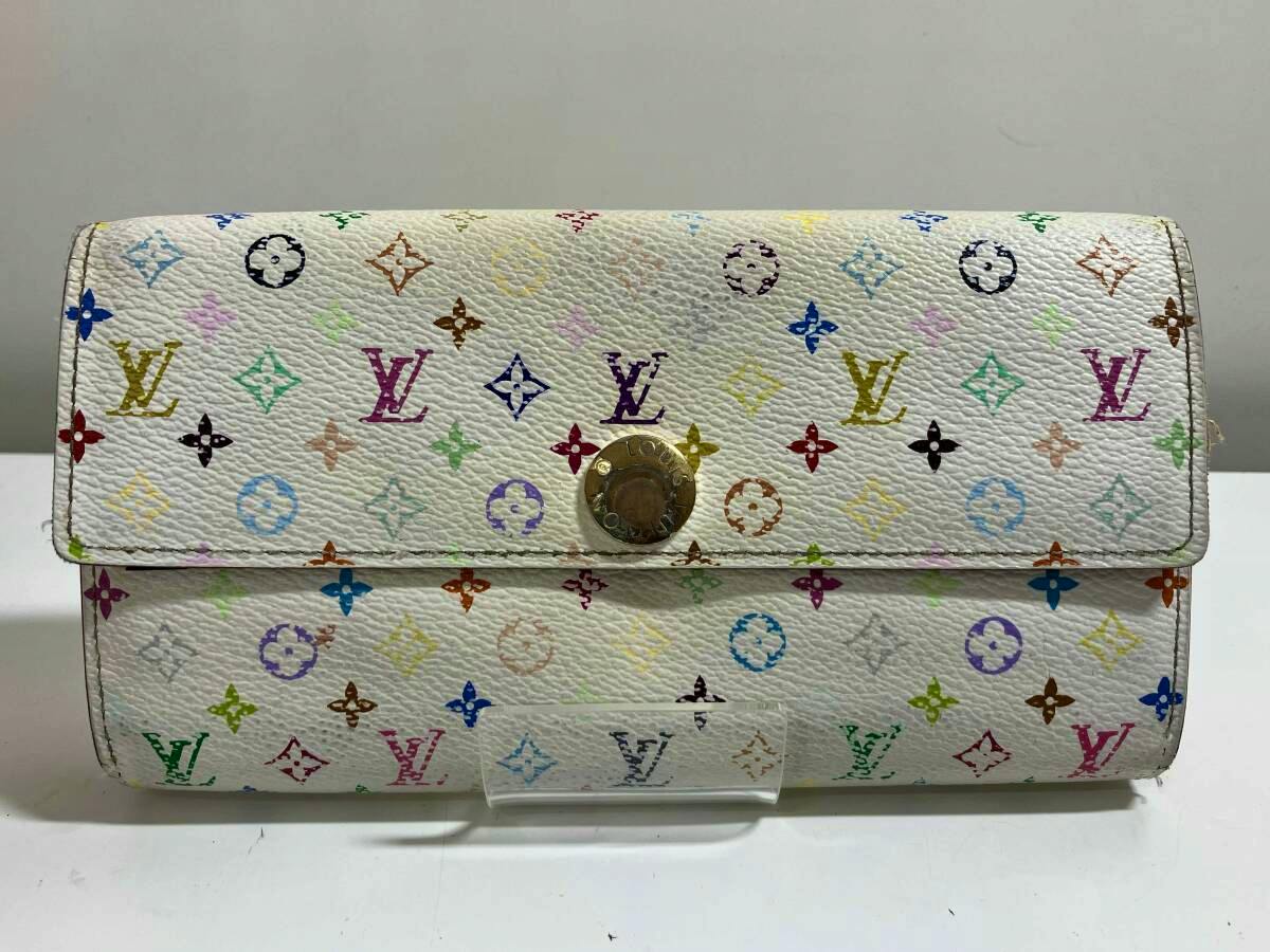 Front view of a white Louis Vuitton multicolor monogram Portefeuille Sarah bi-fold long wallet with a gold-tone snap closure.