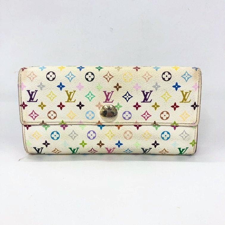 Front view of a white Louis Vuitton multicolor monogram wallet with multicolored LV motifs and a central gold snap closure.