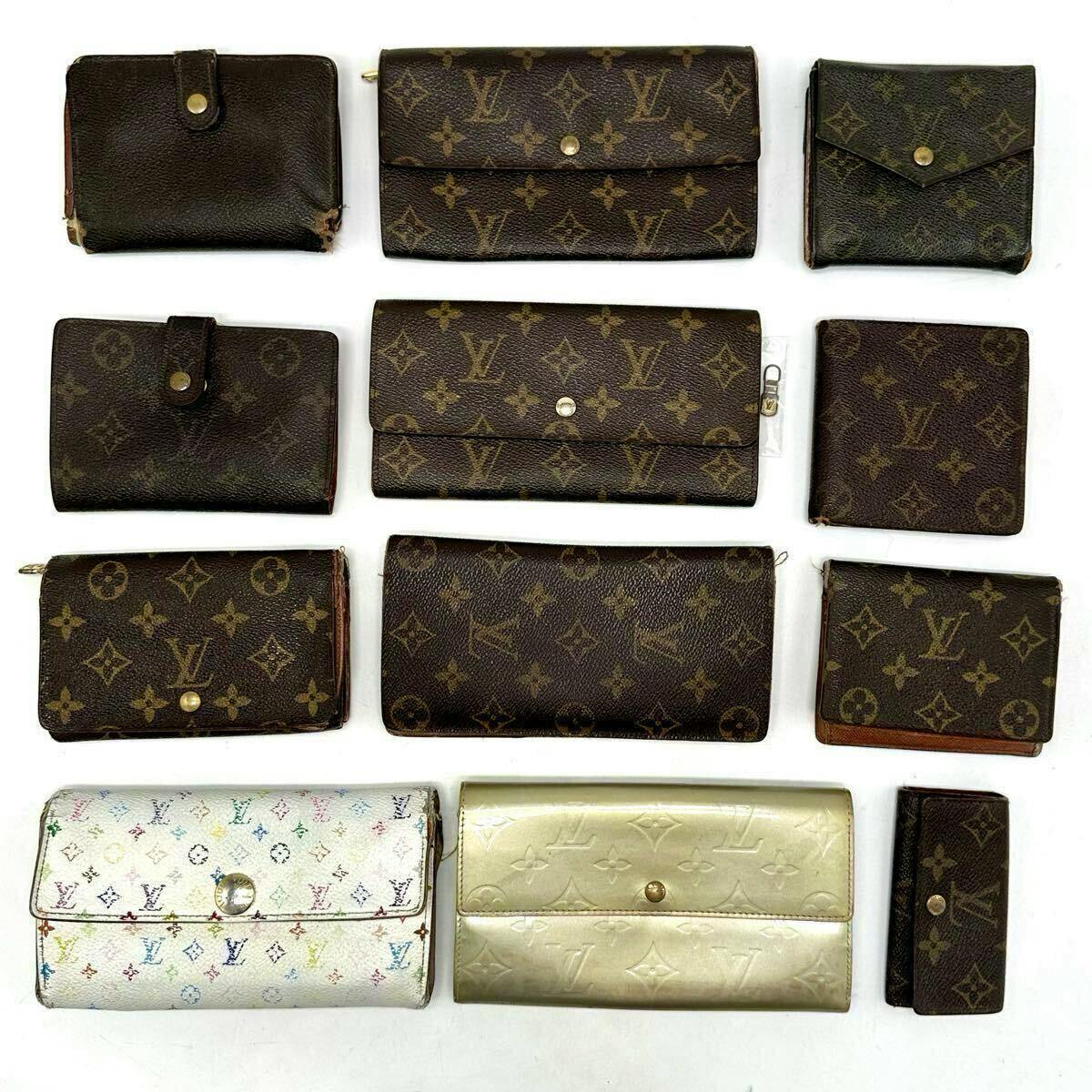 Twelve Louis Vuitton monogram wallets and small leather accessories arranged on a white background.