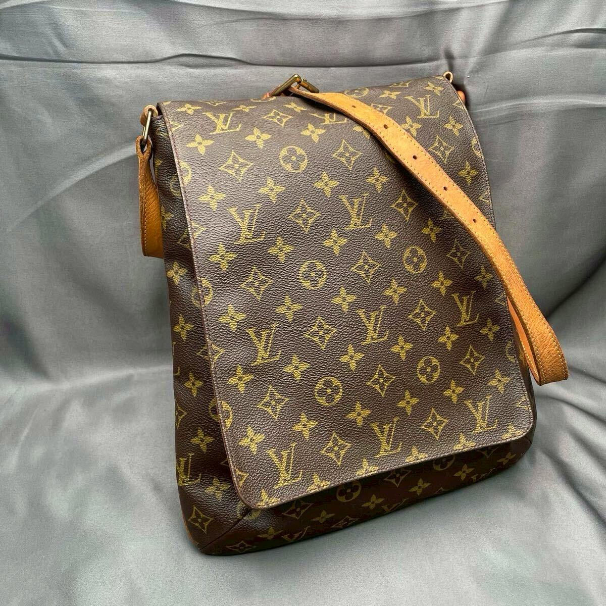 Louis Vuitton monogram Musette shoulder bag with flap and leather shoulder strap shown against a gray background.