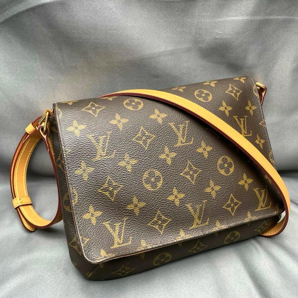Louis Vuitton Monogram Musette Tango shoulder bag on a gray background, showing the front and shoulder strap.