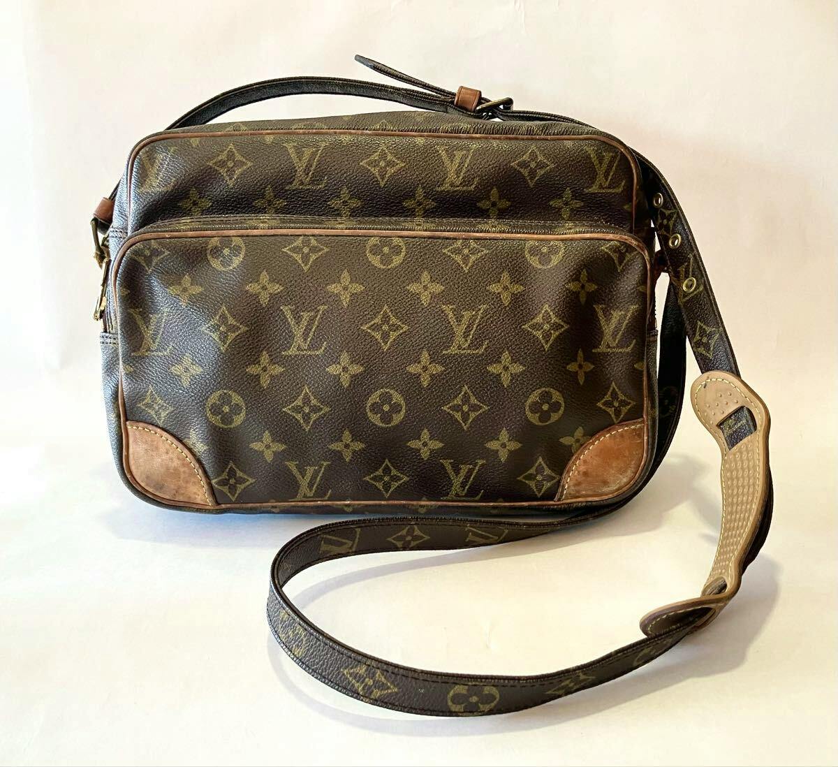Front view of the LOUIS VUITTON Monogram Nile shoulder bag (M45244) showing the monogram canvas, leather trim, and shoulder strap on a white background.