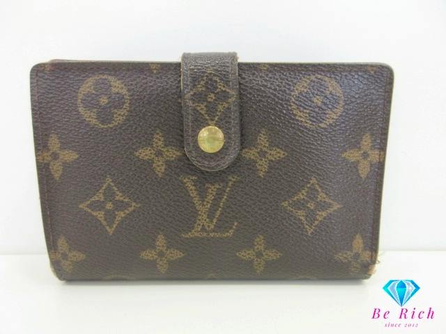 Front view of a Louis Vuitton brown monogram canvas bi-fold wallet with a snap-tab closure.