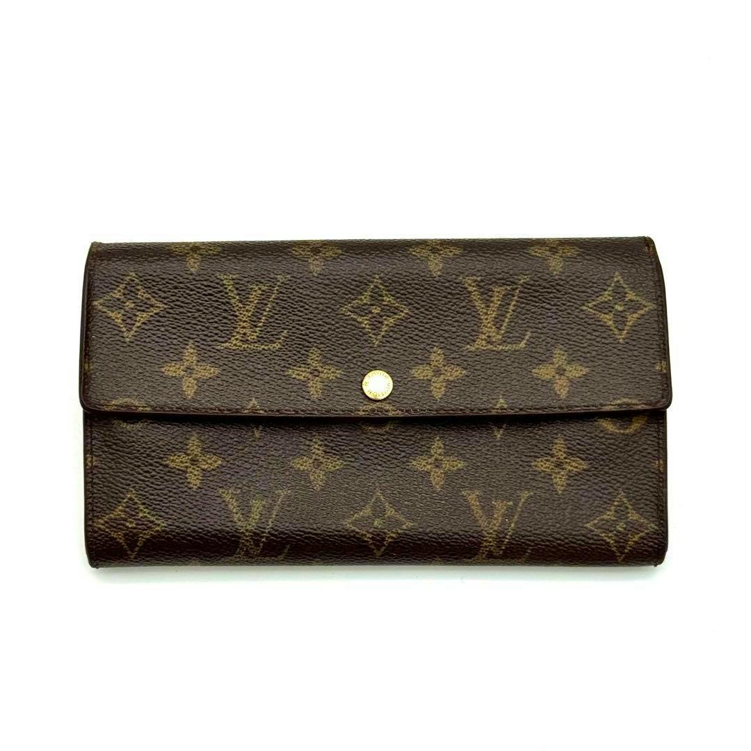 Front view of the Louis Vuitton monogram long wallet (cow leather, model M61725) showing a flap with a central gold snap button.