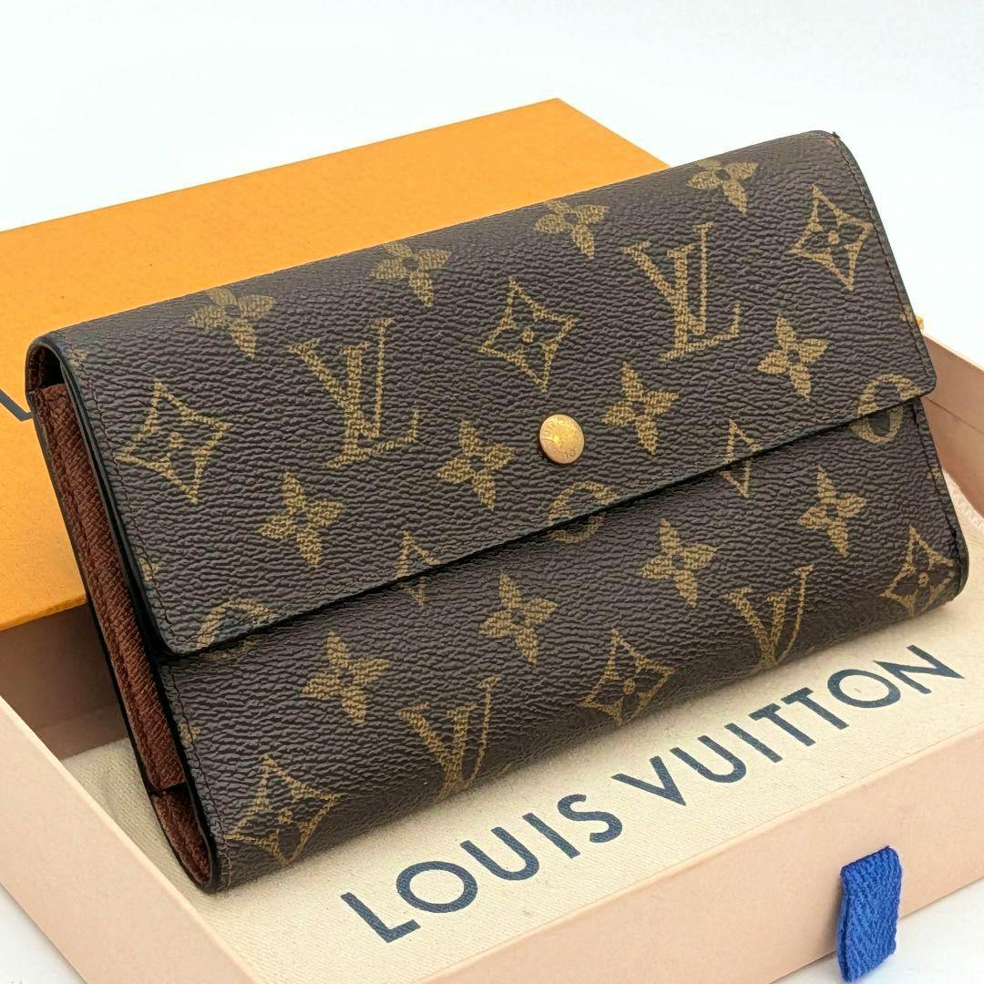 Front view of the Louis Vuitton monogram trifold wallet (cow leather) placed on a Louis Vuitton box.