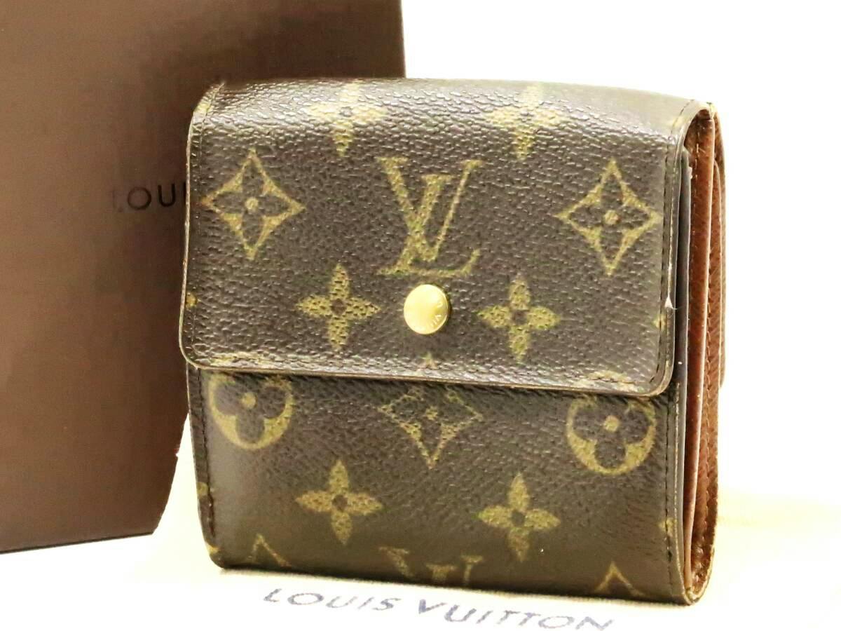 Front view of a Louis Vuitton monogram canvas tri-fold wallet with a snap button closure, shown upright with box in the background.