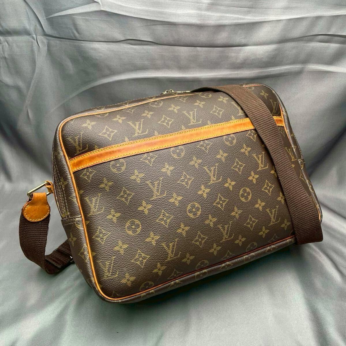 Louis Vuitton Monogram Reporter GM crossbody shoulder bag shown on a gray background.