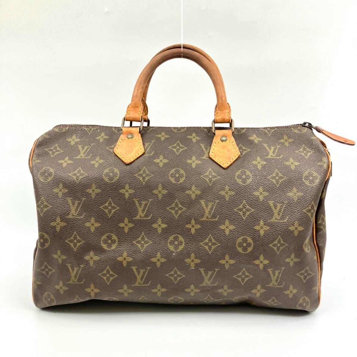 Front view of a Louis Vuitton Monogram canvas Speedy-style handbag with leather handles and zipper.