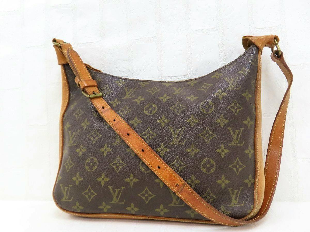 Brown Louis Vuitton monogram shoulder bag with tan calf leather trim and adjustable strap displayed against a white background.